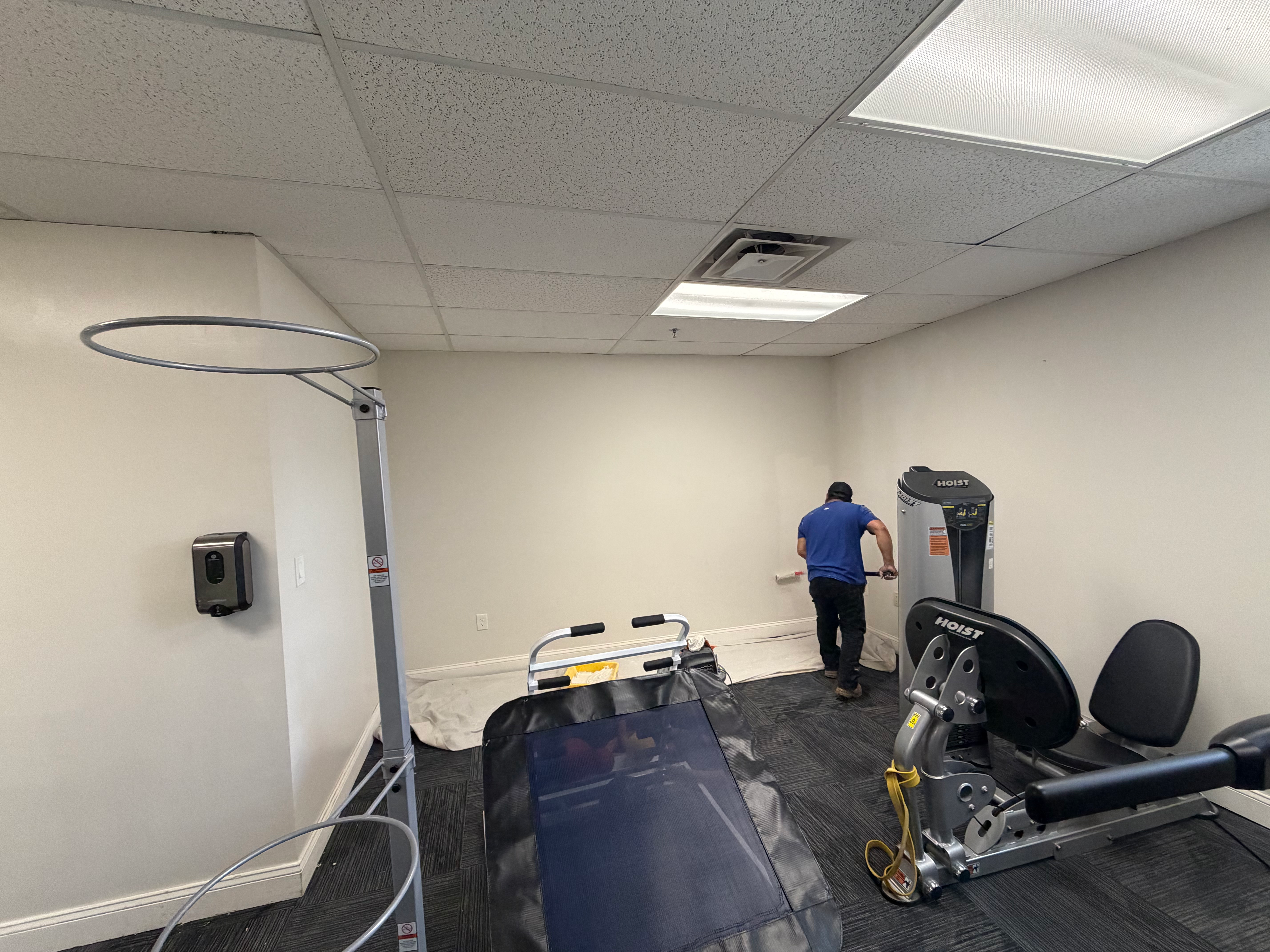 Small-commercial gym space paint maintenance in Bergen County, NJ — drop cloths down, equipment protected, walls refreshed