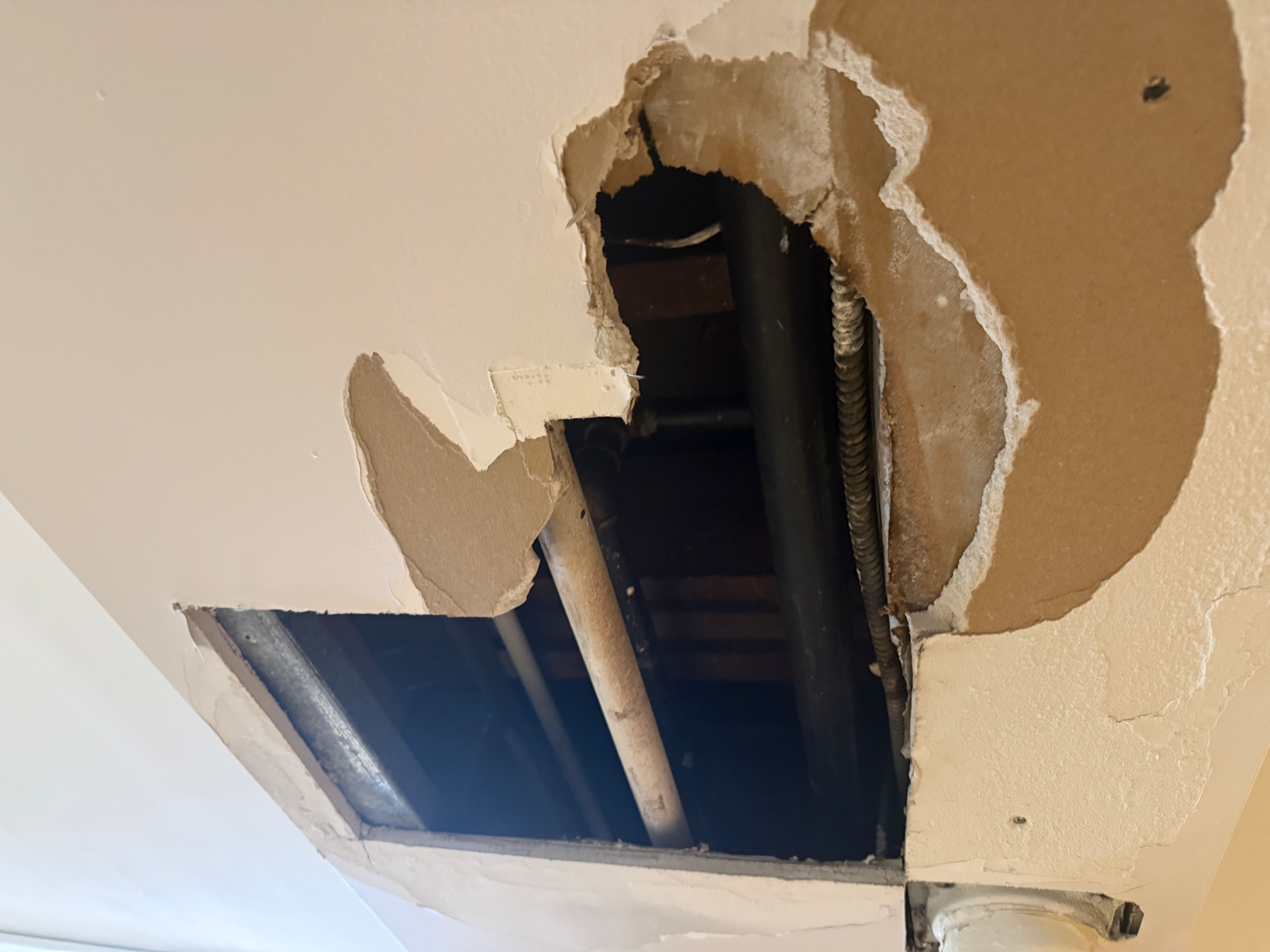 Ceiling drywall water damage before repair in Bergen County, NJ — full demolition required around damaged area before patch