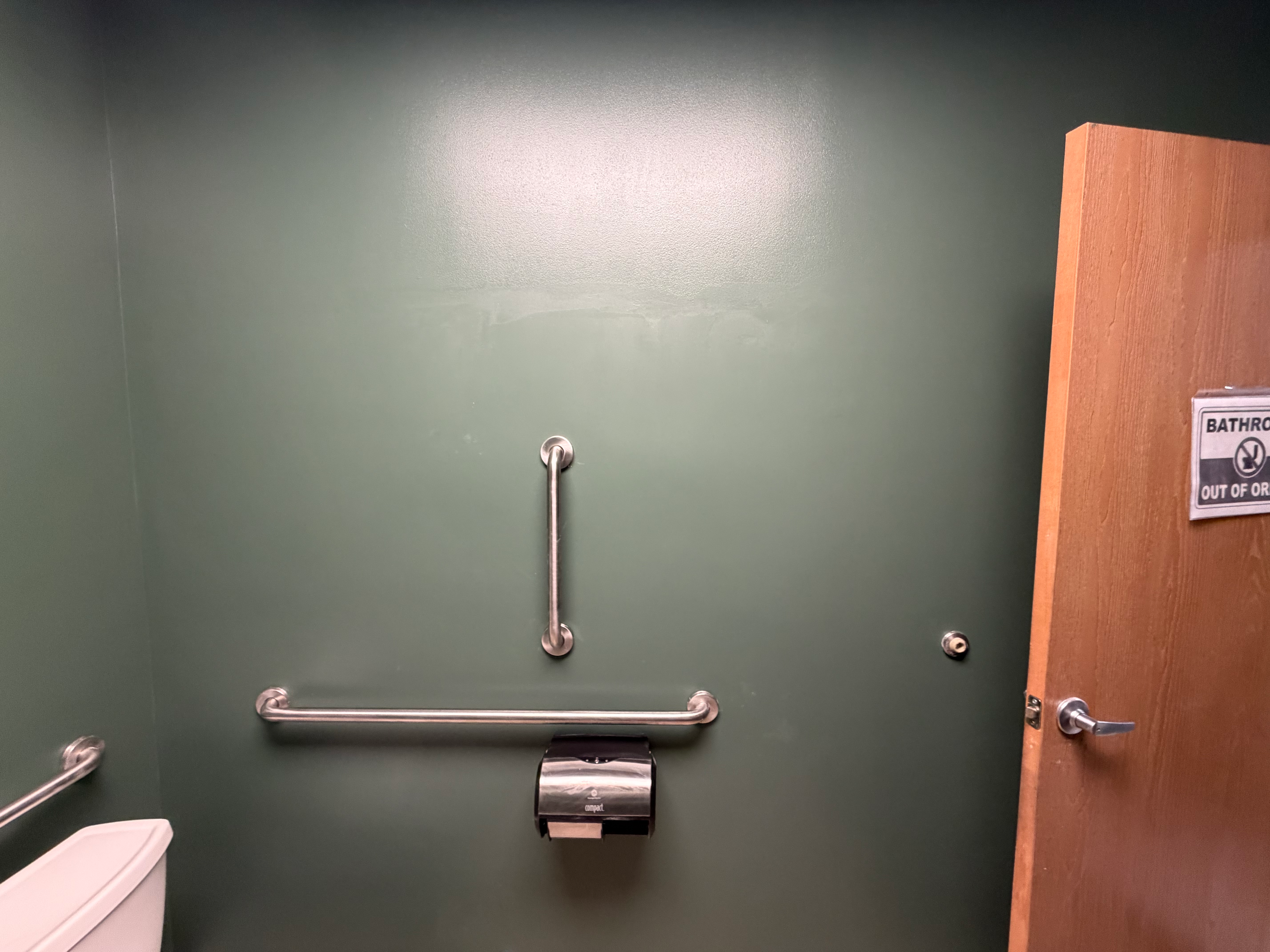 ADA-compliant grab bar install during commercial property maintenance in Bergen County, NJ — bars blocked into the wall for real support, not toggle bolts