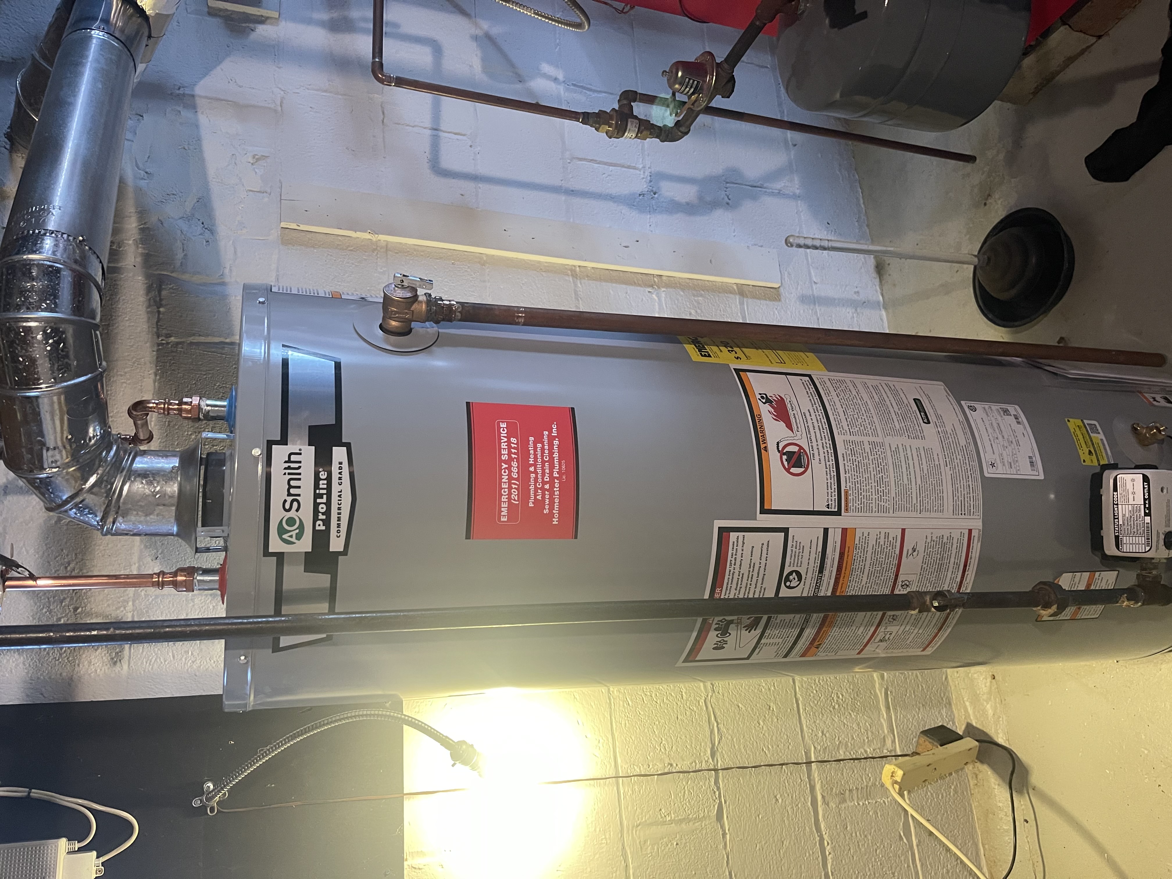 Heating technician servicing a hot water boiler system in a Montvale NJ home basement