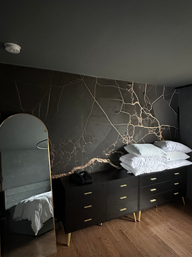 Finished bedroom with a black accent wall by Innovative Home Improvement.