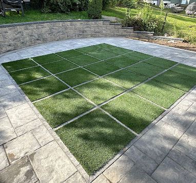 Backyard grass area divided into squares, landscaped by Innovative Home Improvemen