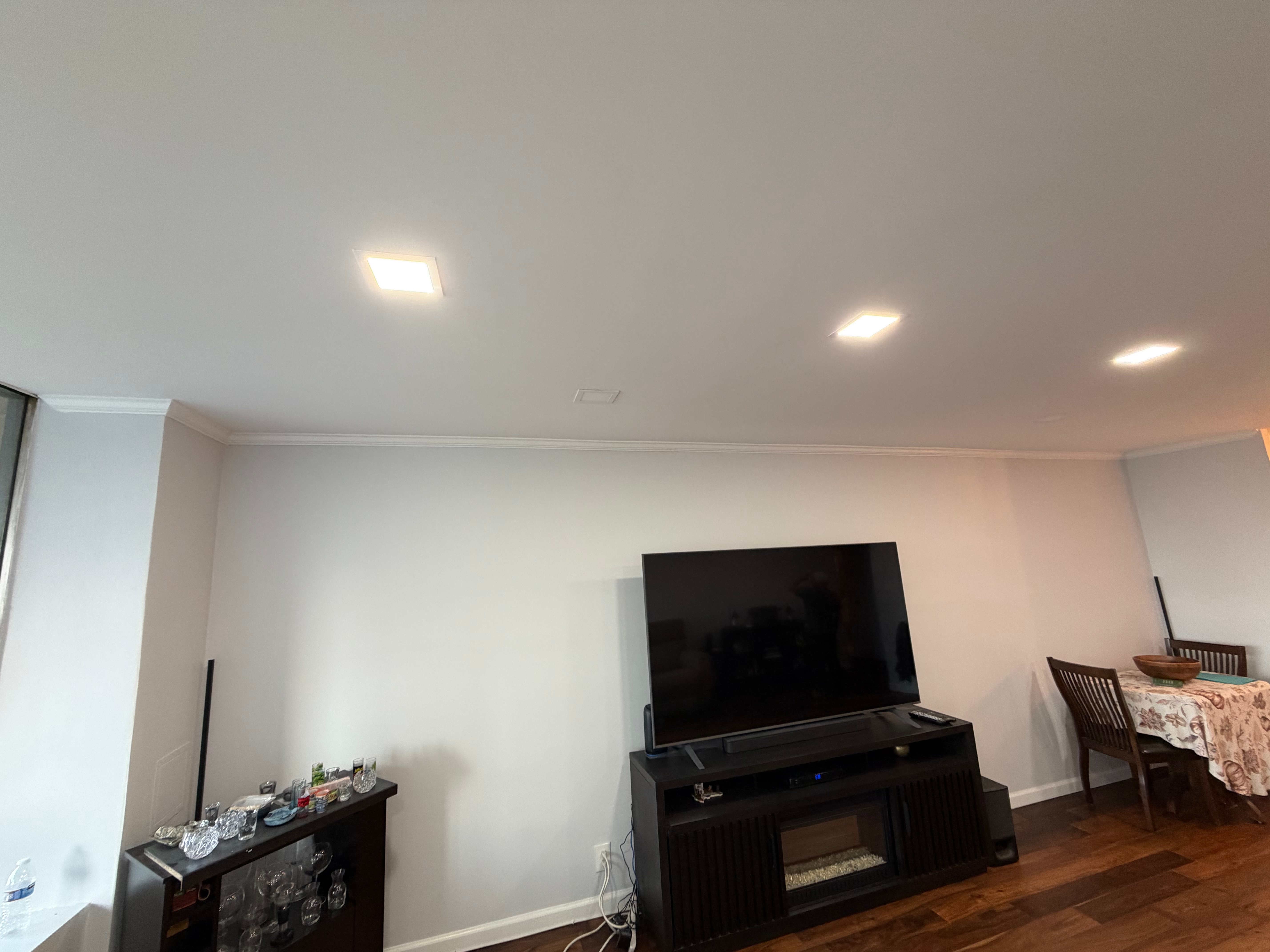 Hardwood floor finished in Bergen County, NJ — open dining and living room with new hardwood flooring and crown molding