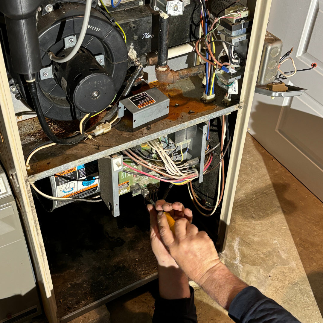 Heating technician servicing a hot water boiler in a Park Ridge NJ home