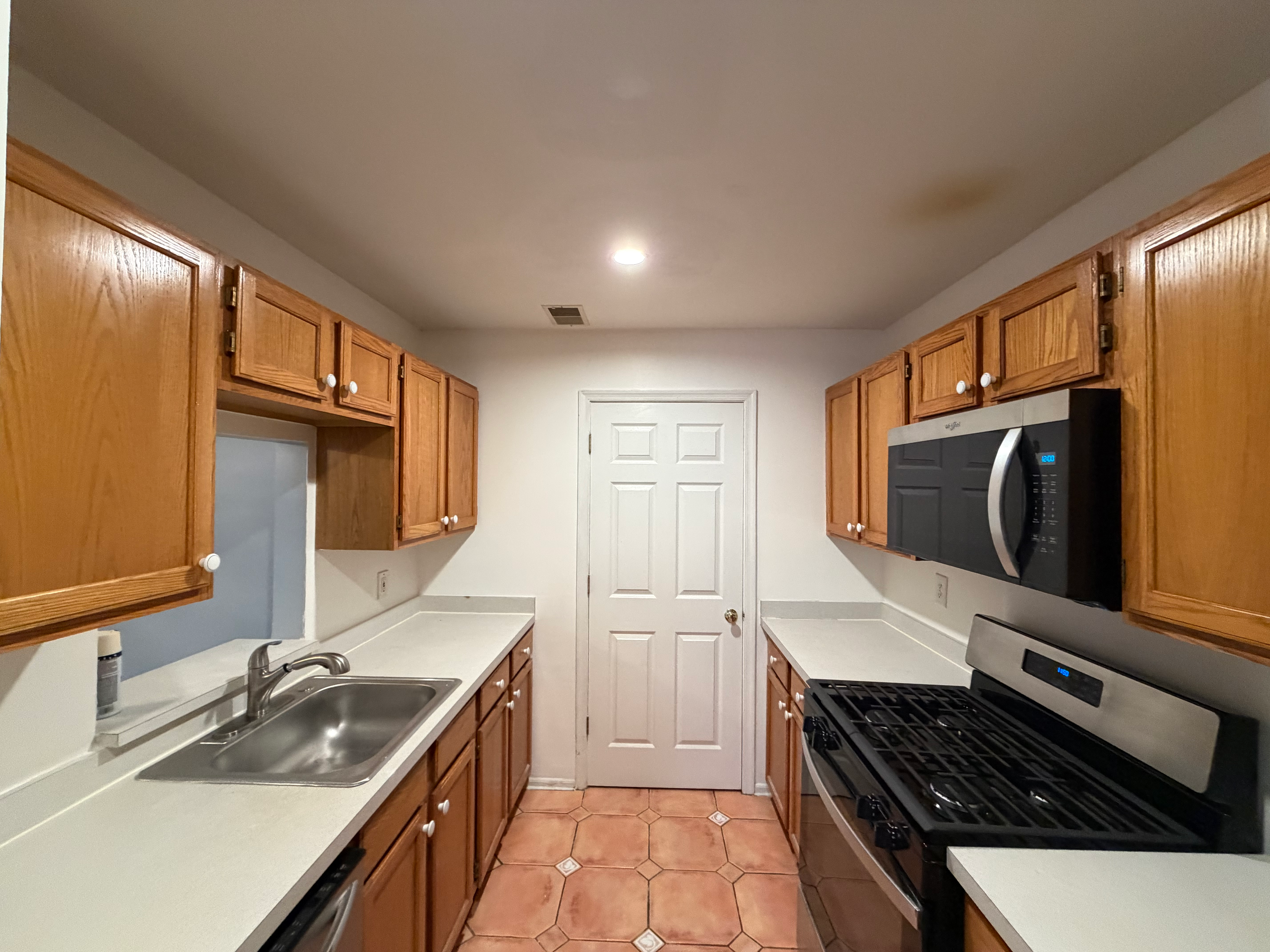 Galley kitchen flooring install in Bergen County, NJ — patterned tile floor finished with new baseboards