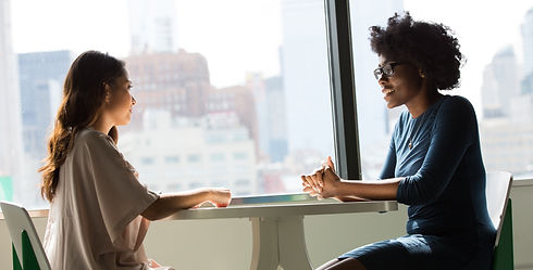 two women sitting beside table and talking_edited.jpg