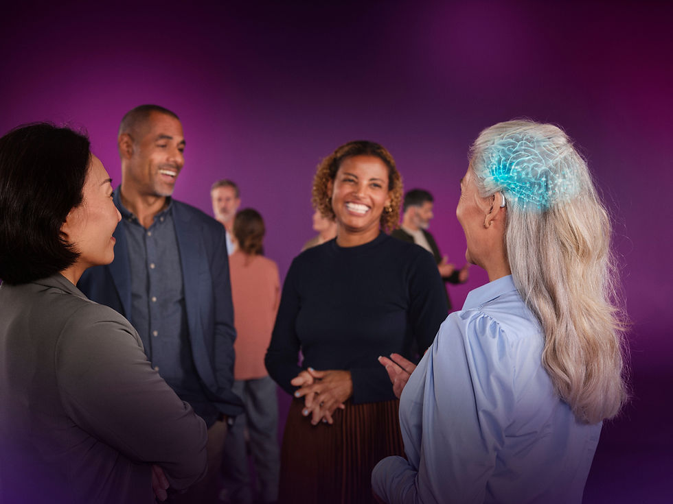 A woman with a hearing aid engages in a lively conversation with friends, highlighting the power of modern technology in social interaction.