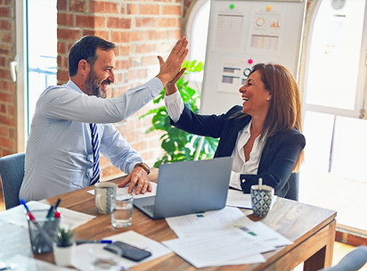 Two middle age business workers smiling 