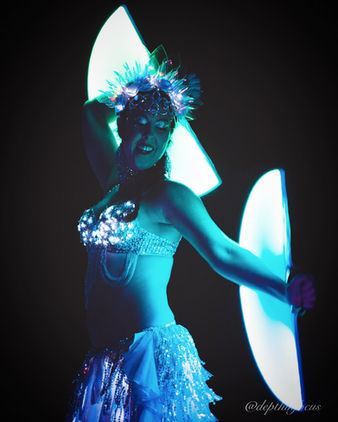 Mystica Fay performing LED belly dance at a flowcase with LED fans