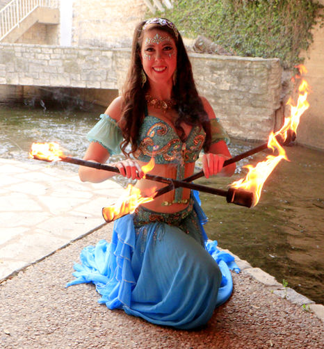 Mystica Fay performing fire belly dance with fire double staffs aka fire batons