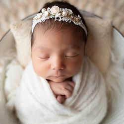 A newborn peacefully asleep in a cozy blanket.