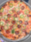 Pepperoni and jalapeƱo pizza on a wire cooling rack