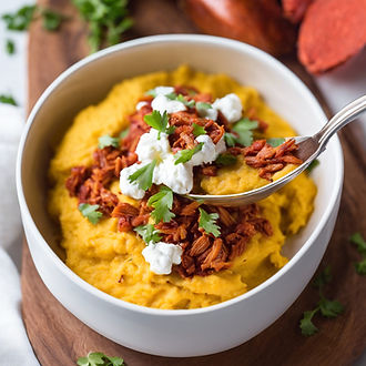 Achiote Spiced Shredded Chicken__creamy goat cheese polenta__on a porcelain spoon