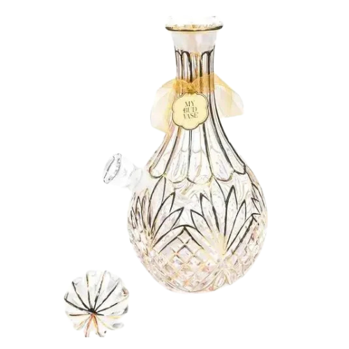 Ornate glass decanter with floral patterns and "My Bud Vase" label, accompanied by a matching lid, set against a plain background.