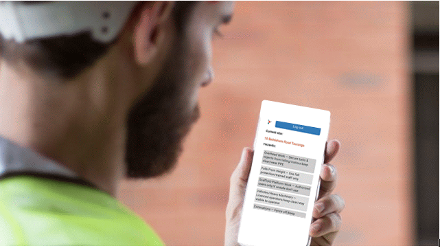 Worker Looking at mobile screen.gif