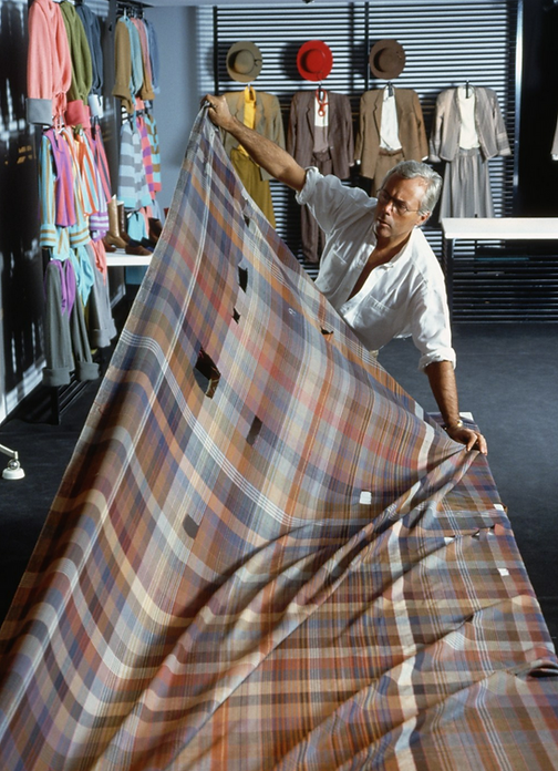 Armani Looking at Fabric.png