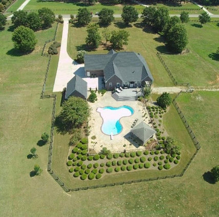 Ariel view of home with yard maintenance and tree and shrub installation.