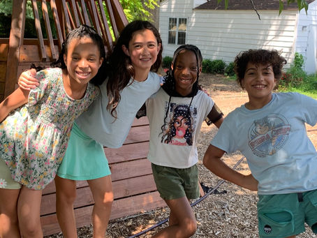 A group of Camp Rippling Brook campers and counselors smiling together outdoors, showing connection, inclusion, and a strong sense of community.