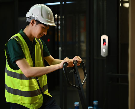 warehouse-worker-pulling-pallet-truck-stack-with-b-2024-12-04-15-35-06-utc.JPG