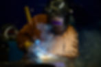 Welder welding a custom architectural fixture