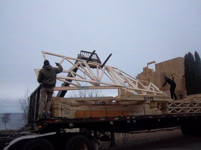 Croftville Road Cottages. Here you can get a sense at just how fragile the large trusses are when trying to unload and position them off the trailer.