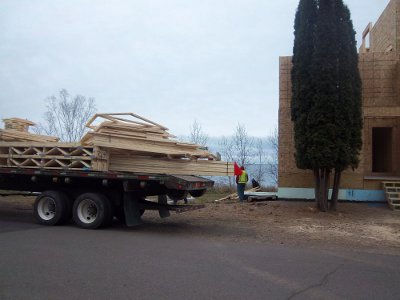 Croftville Road Cottages. The first of the trusses to be unloaded are being stacked down near Cottage Unit 6 on the east side of the inn.
