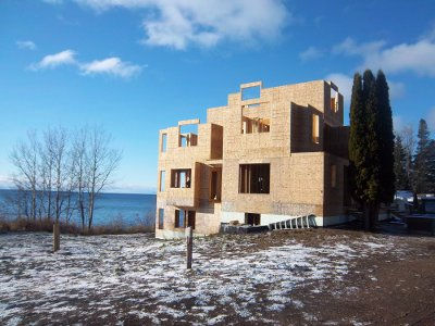Croftville Road Cottages. The walls on the east side are sheathed and ready for the roof trusses to arrive.