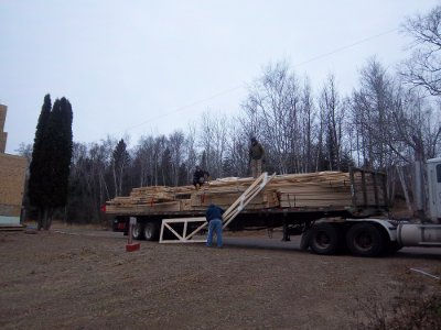 Croftville Road Cottages. Tony, Jason, and Ethan unload some of the more unusual shaped trusses by hand.