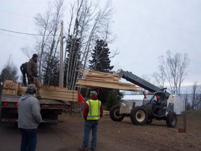 Croftville Road Cottages. Here is our last pile of trusses being removed from the trailer. The remaining trusses are for a house somewhere else in Grand Marais.