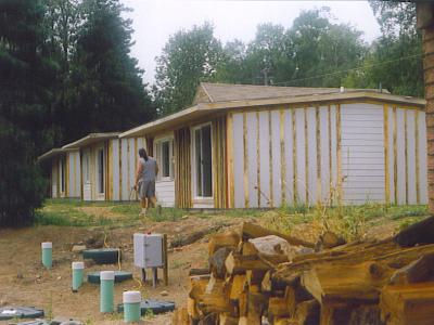 Croftville Road Cottages. Here we see the three cottages from the lakeside that are resided and ready for painting.