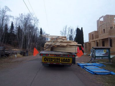 Croftville Road Cottages. The large load has so many trusses of different shapes and sizes that there doesn't seem to be any order on how they are stacked on the trailer.
