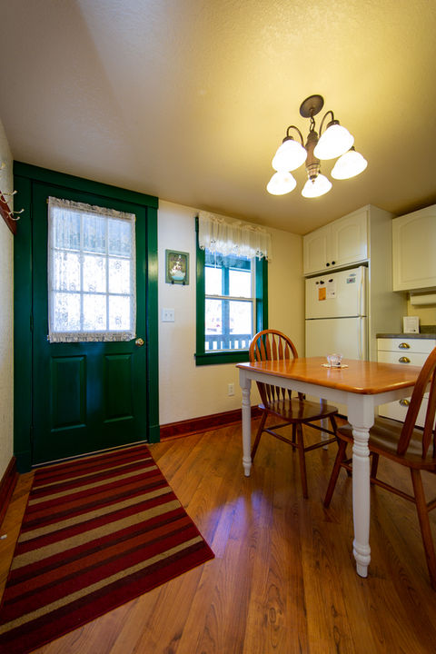 Croftville Road Cottages. Your main entry is into the kitchen in Cottage #1. The table makes it easy to set down your grocery bags and coolers as you put your favorite food and beverage supplies away.