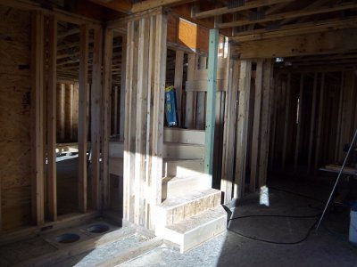 Croftville Road Cottages. Getting ready for the roof trusses means having as many ways possible for Jason's crew to get to the roof. Before Jason arrives, Mike is finishing the stairway in Inn Suite 5.
