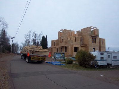 Croftville Road Cottages. The trusses barely fit on a single load. The good news is that none of them individually are so large that they would need a crane to place them. Jason's large lift with Jordan at the controls can get the job done.