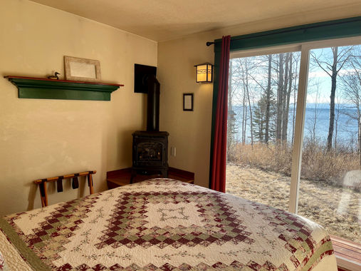 Croftville Road Cottages.
How can it get better than this. Imagine laying on the plush queen bed reading a good book within the glow of the gas stove. As you look out the patio door you have Lake Superior laid out in front of you in Cottage #3.