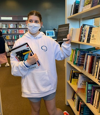 Lauren in pure autistic bliss in a bookstore.