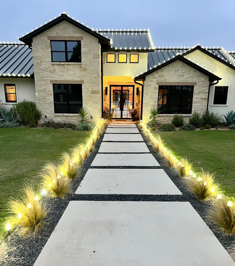Southwestern-style landscape in Shadow Lakes Community, Wills Point, TX, with ornamental grasses accentuating the walkway and front entrance.