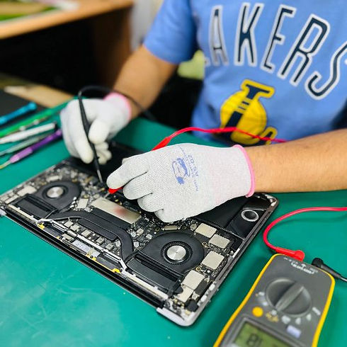 technician repairing a laptop