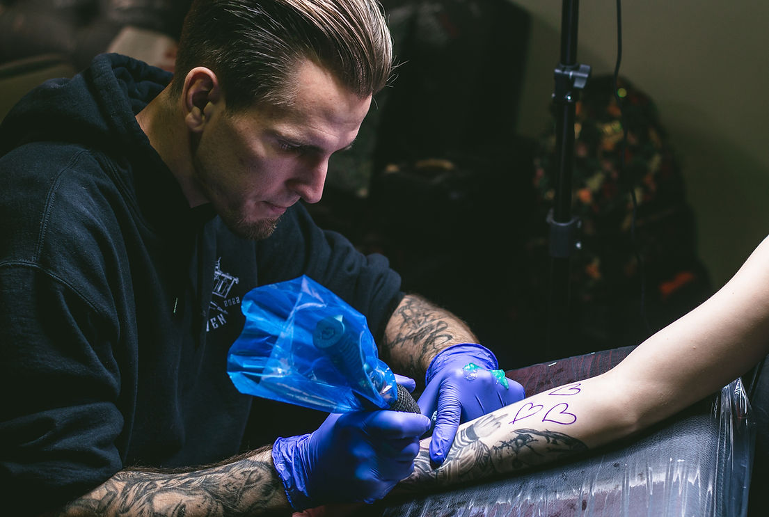 Michael tattooing on Maddie’s arm.jpg