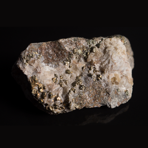 Gold-bearing sulfide ore with pyrite and arsenopyrite crystals showing metallic luster and dense mineralization.