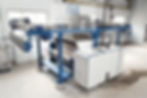 Close-up view of fabric being processed through a decatising machine