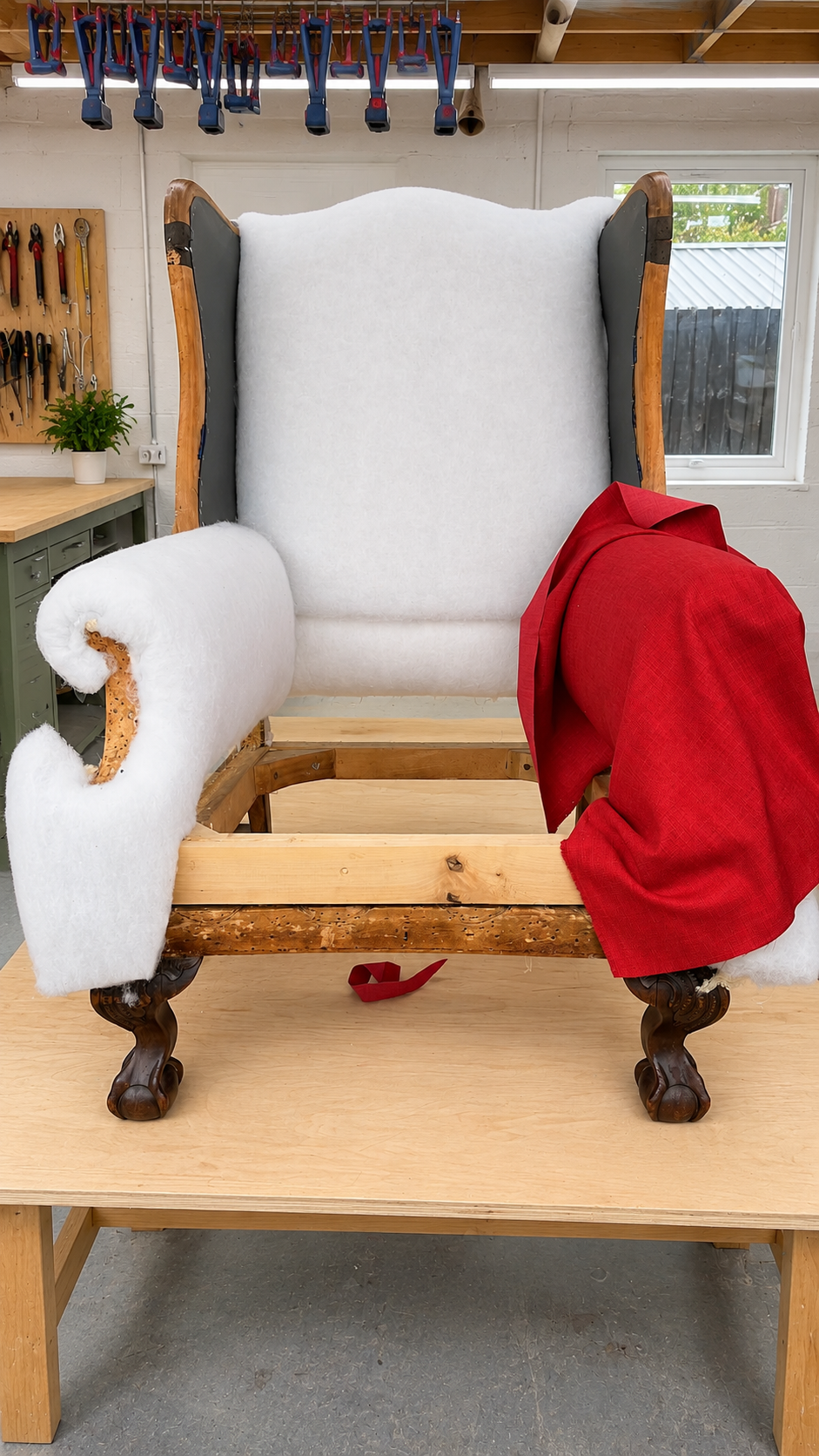 Image of the process of upholstering a red armchair
