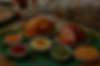 Cooked turkey and sliced ham displayed with bowls of various sauces and condiments on a table.