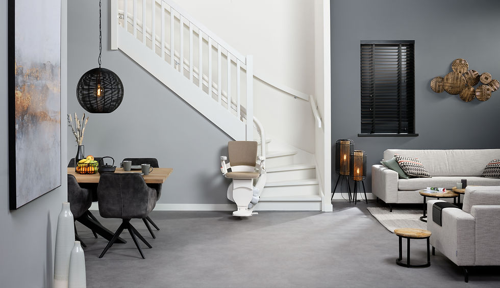 Imagen de una sala con una escalera en el fondo que tiene instalada una silla salvaescalera