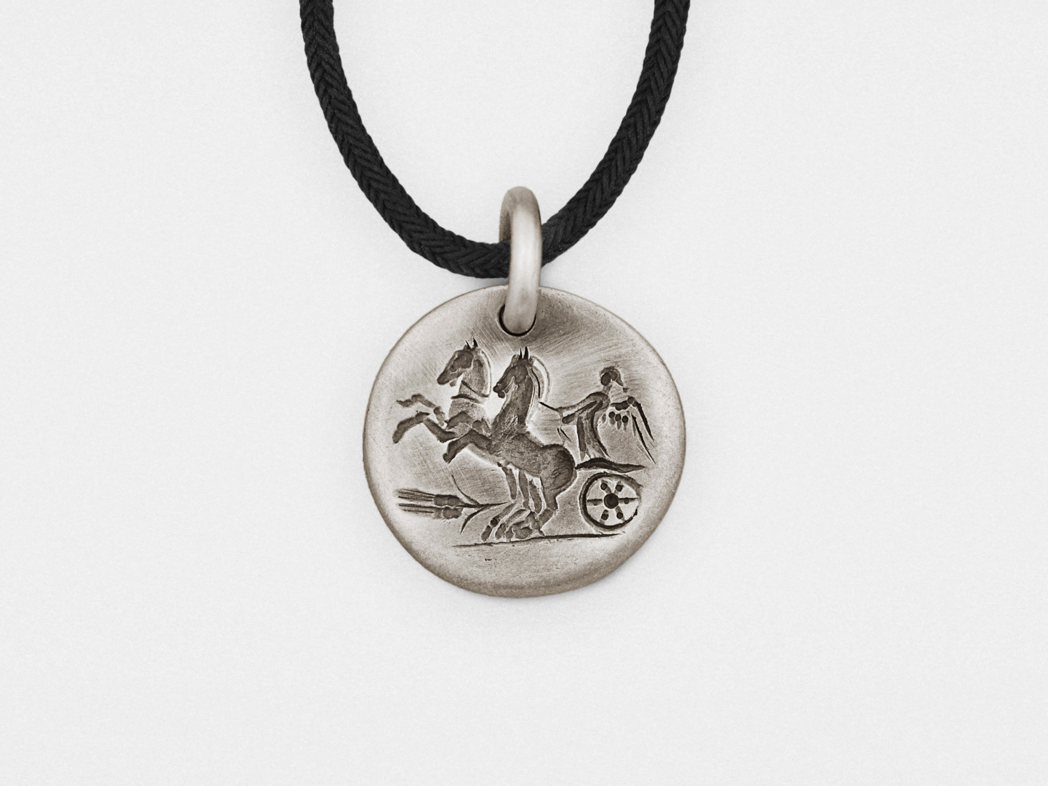 "Sterling silver “Chariot” intaglio pendant with a carved chariot design set in a polished frame."