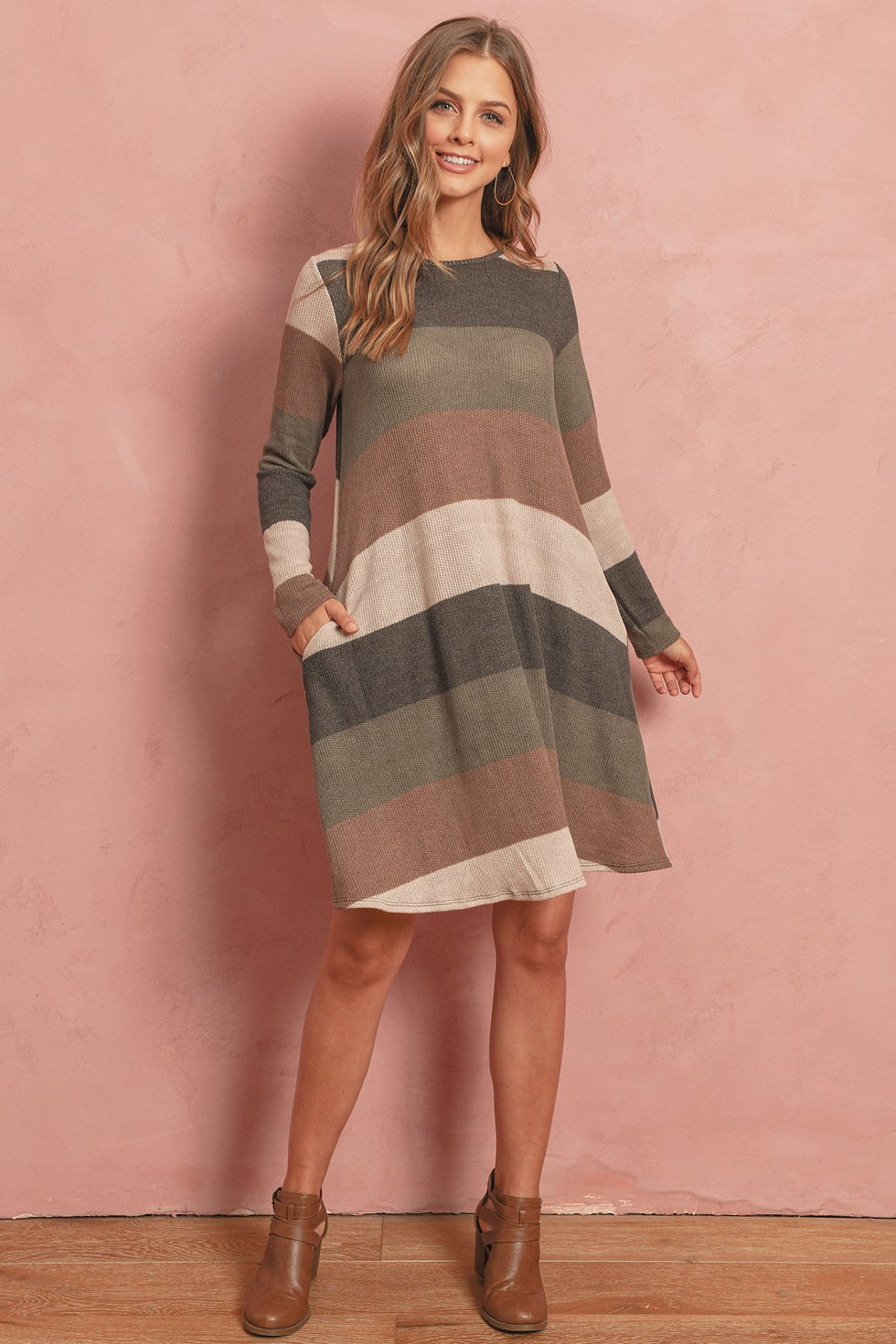 Woman wearing striped dress with pockets, new item, shop.
