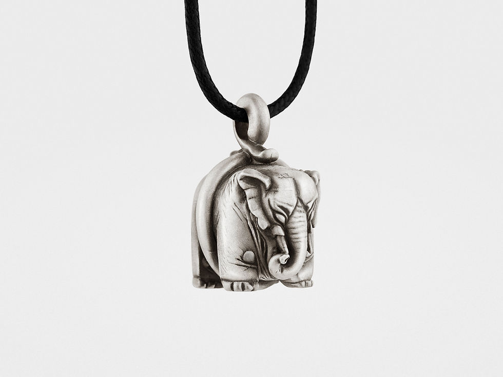 "Sterling silver elephant pendant with detailed carving and a polished finish, hanging from a simple silver chain."