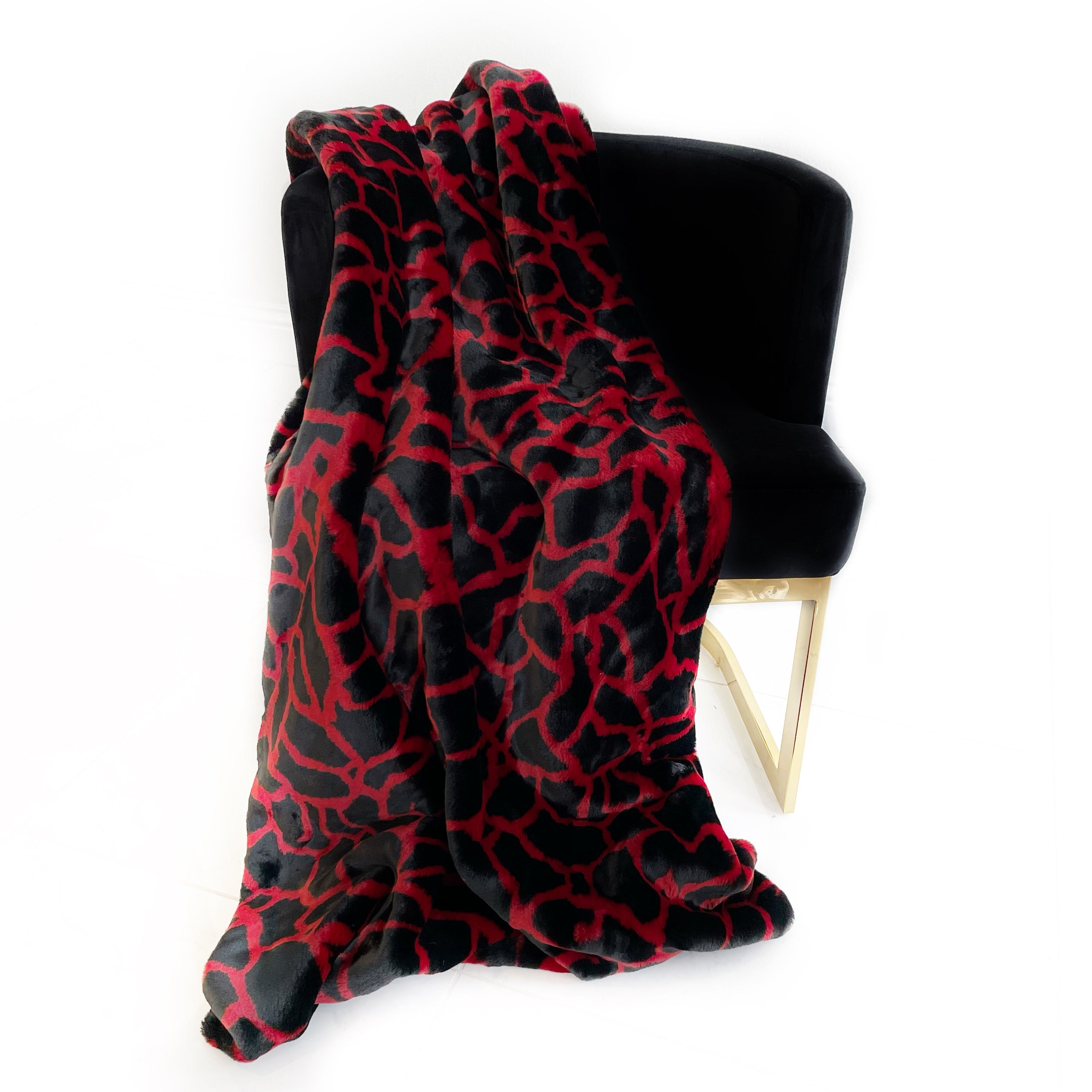 "Red and black faux fur throw blanket – a cozy and stylish home decor accent."