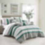 “Chic comforter set in soft microfiber with matching pillows, adding a touch of modern elegance to the bedroom.”