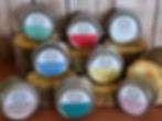 Variety of tallow lotions in tins on wood display